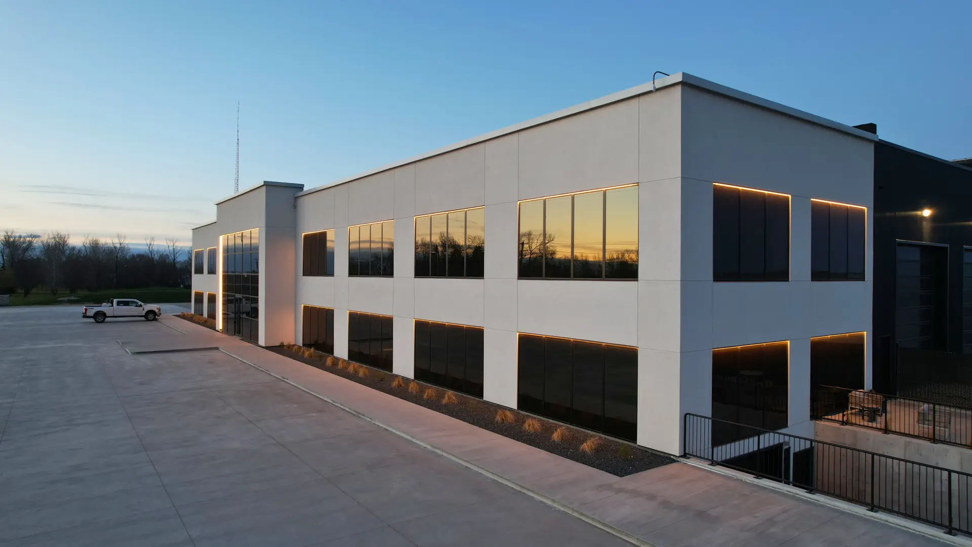 Commercial building with premium EIFS exterior finish at dusk, completed by IN-EX Plastering and Stucco in Manitoba