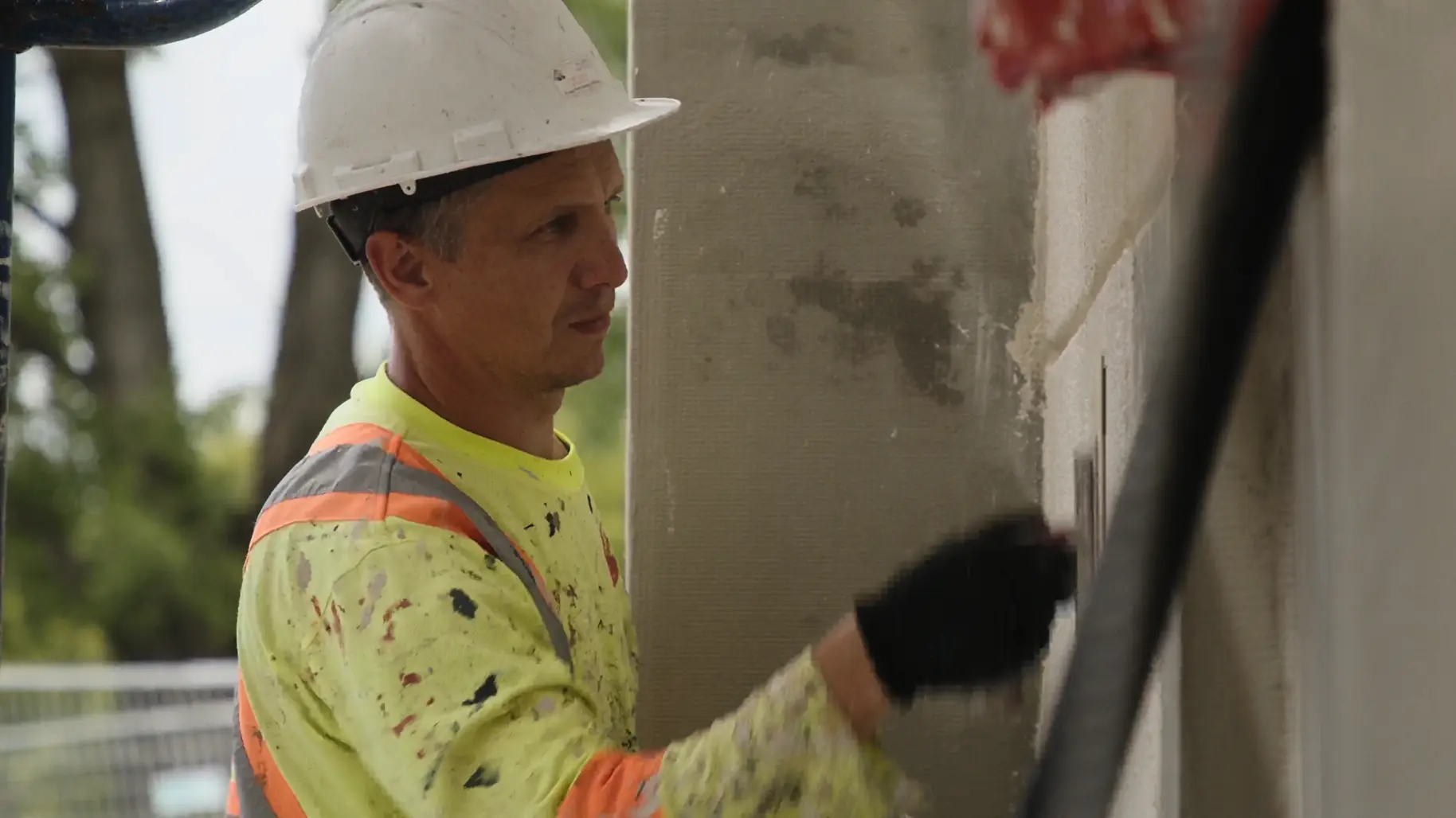 IN-EX craftsman hand-finishing a plaster wall surface