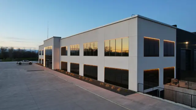 Fast Bro commercial building at dusk with white EIFS exterior