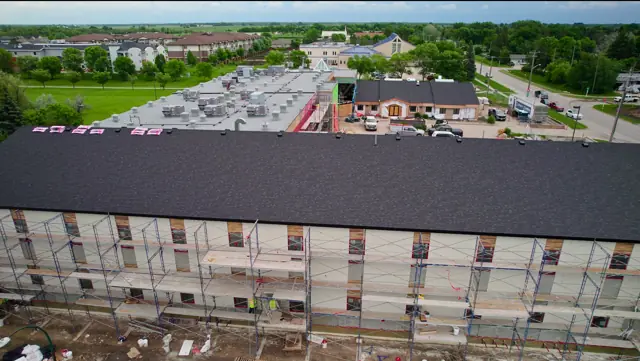 Wide view of college campus during envelope construction
