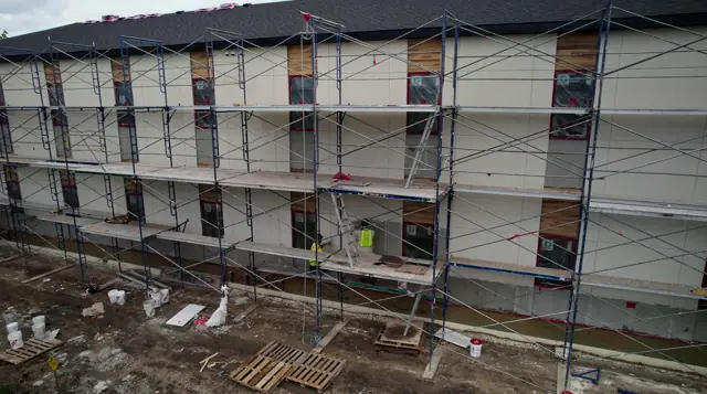 Steinbach Bible College building with scaffolding during EIFS installation