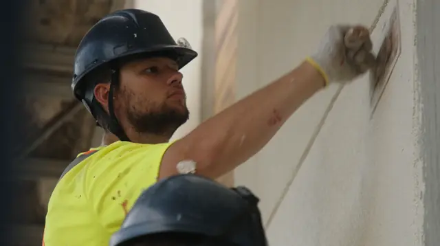 IN-EX installer hand-finishing EIFS base coat