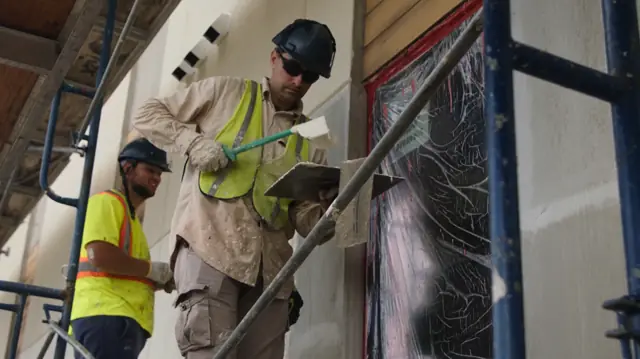 IN-EX team working together on wall section